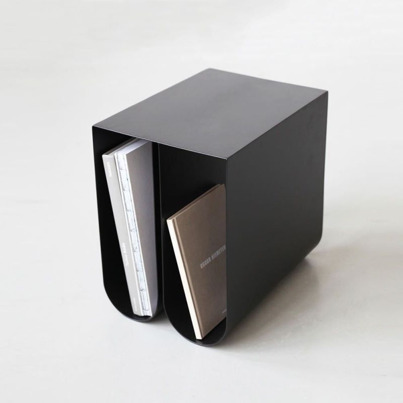 black curved side table styled in an interior by Kristina Dam