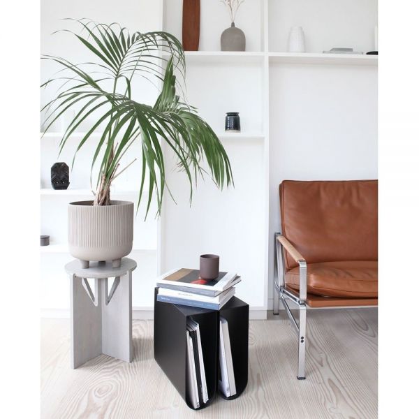 black curved side table styled in an interior by Kristina Dam